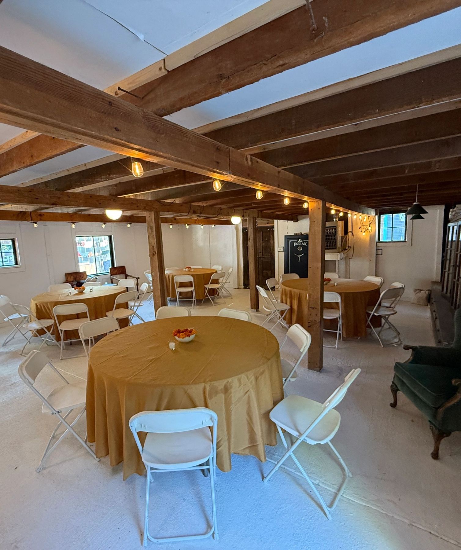 Round dinner tables set under timber beams