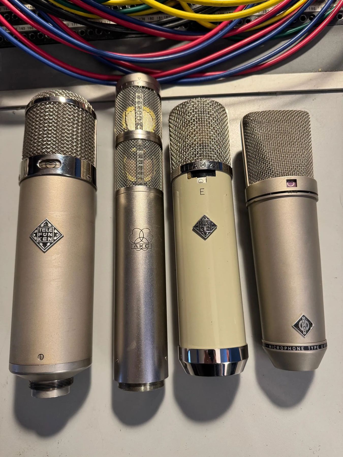 Four tube microphones laid side by side